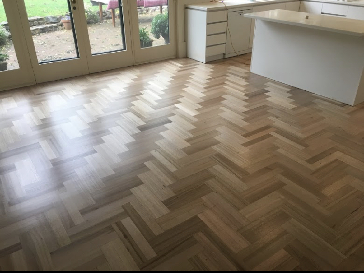 Polished herringbone parquet timber floor